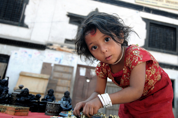 Helping her mom to tend the souvenir stall